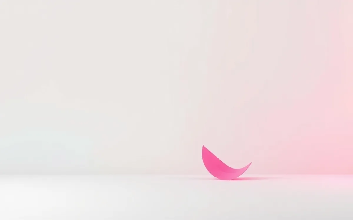 Folha rosa curva em superfície branca com fundo degradê rosa.