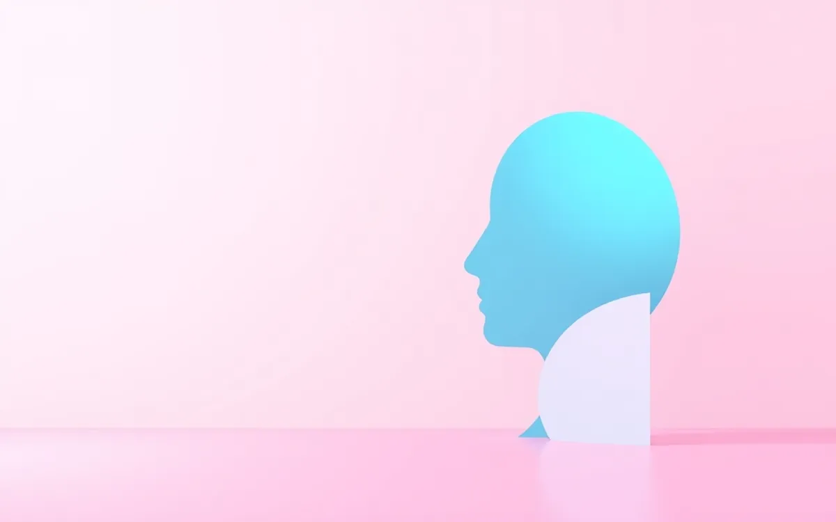 Silhouette de cabeça humana em azul sobre fundo rosa claro e chão rosa.